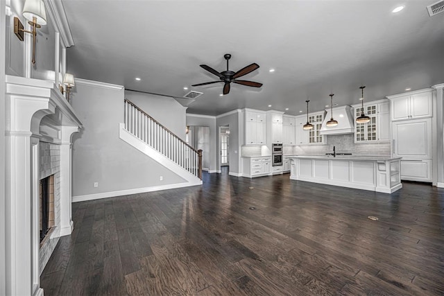 unfurnished living room featuring baseboards, recessed lighting, visible vents, and a ceiling fan