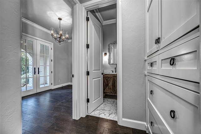 bathroom with a chandelier, crown molding, french doors, and a textured wall