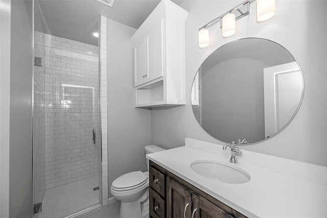 bathroom featuring a stall shower, toilet, and vanity