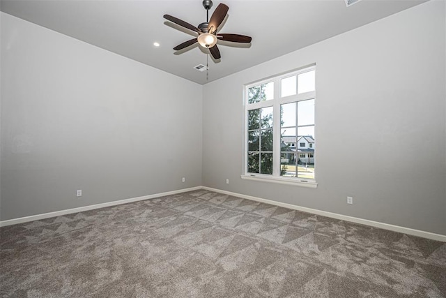 empty room with carpet flooring, ceiling fan, and baseboards