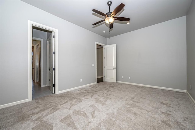 unfurnished bedroom featuring baseboards, a ceiling fan, and carpet flooring