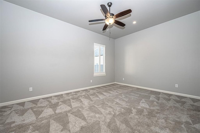 carpeted spare room featuring baseboards, recessed lighting, and a ceiling fan
