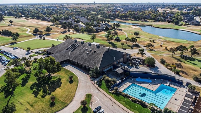 drone / aerial view featuring golf course view and a water view