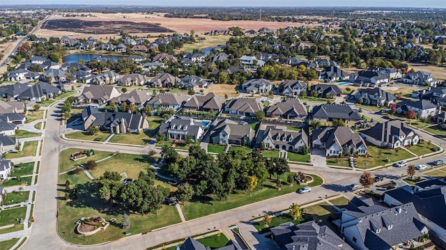 drone / aerial view featuring a residential view and a water view
