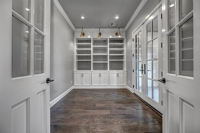 interior space featuring dark wood finished floors, ornamental molding, baseboards, visible vents, and french doors