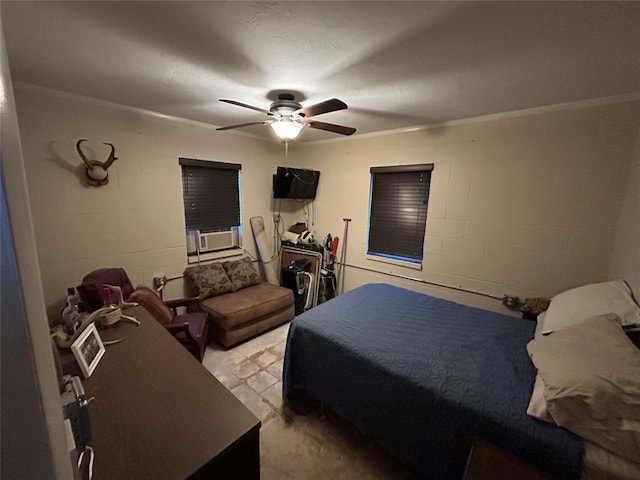 bedroom featuring a ceiling fan, cooling unit, and concrete block wall