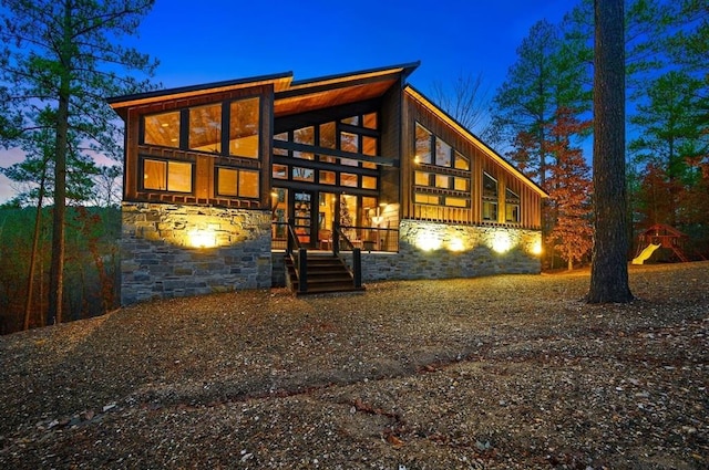 back of house with stone siding