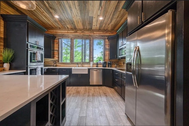 kitchen with light countertops, light wood-type flooring, recessed lighting, wooden ceiling, and appliances with stainless steel finishes