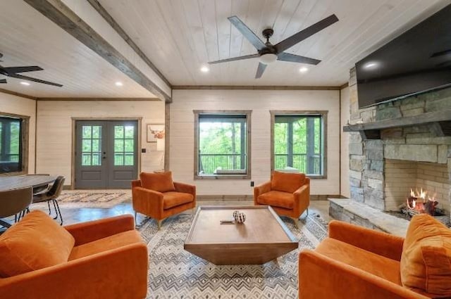 living room featuring plenty of natural light, wooden ceiling, and ceiling fan