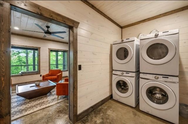 washroom featuring a ceiling fan, wooden walls, wooden ceiling, stacked washer and dryer, and laundry area