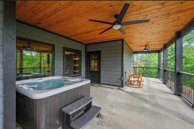 view of patio featuring a ceiling fan and a hot tub