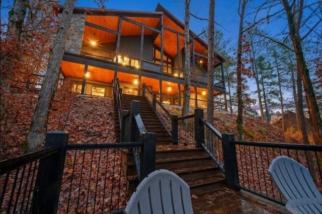 back of house featuring stairs