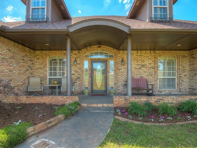 10711 Crystal Creek Dr, Mustang, OK 73064 - entrance to property featuring brick siding and a porch
