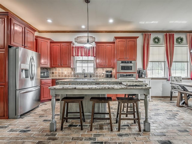 10711 Crystal Creek Dr, Mustang, OK 73064 - kitchen with stainless steel appliances, decorative backsplash, a breakfast bar area, and brick floor
