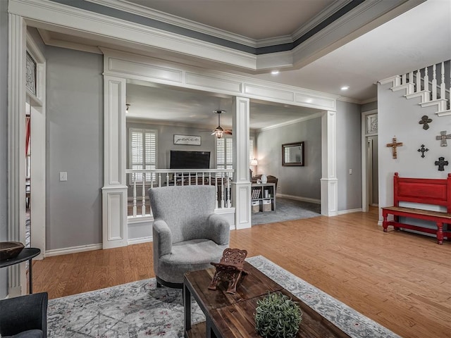 10711 Crystal Creek Dr, Mustang, OK 73064 - living area featuring a ceiling fan, wood finished floors, stairway, and crown molding