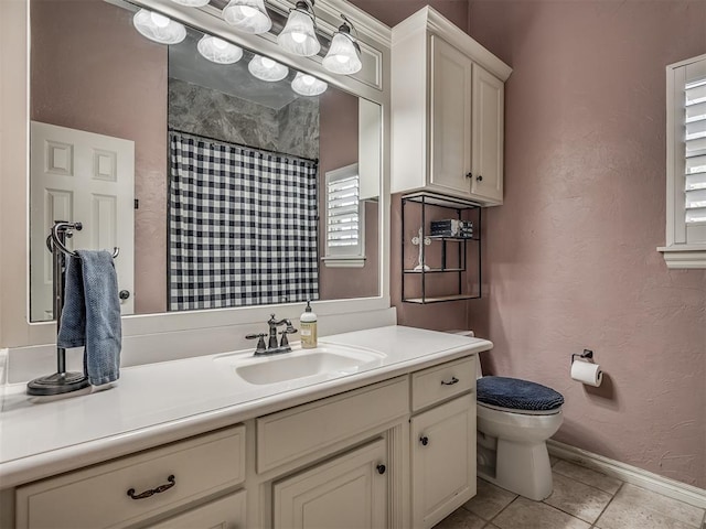 10711 Crystal Creek Dr, Mustang, OK 73064 - full bath featuring tile patterned flooring, toilet, vanity, baseboards, and a shower with shower curtain