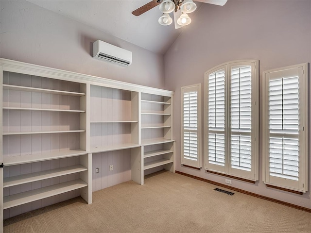 10711 Crystal Creek Dr, Mustang, OK 73064 - interior space featuring light carpet, a wall unit AC, vaulted ceiling, visible vents, and a ceiling fan