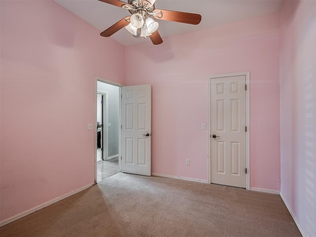 10711 Crystal Creek Dr, Mustang, OK 73064 - unfurnished bedroom featuring light colored carpet, baseboards, and a ceiling fan