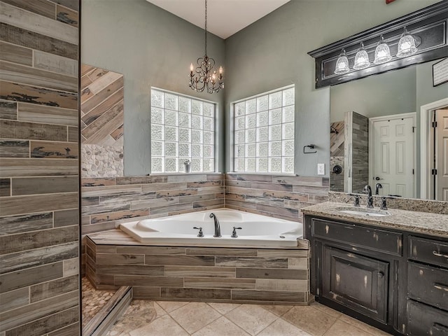 10711 Crystal Creek Dr, Mustang, OK 73064 - full bath featuring an inviting chandelier, a garden tub, vanity, and tile patterned flooring