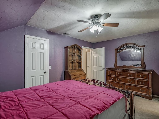 10711 Crystal Creek Dr, Mustang, OK 73064 - bedroom with a ceiling fan, visible vents, carpet floors, and a textured ceiling