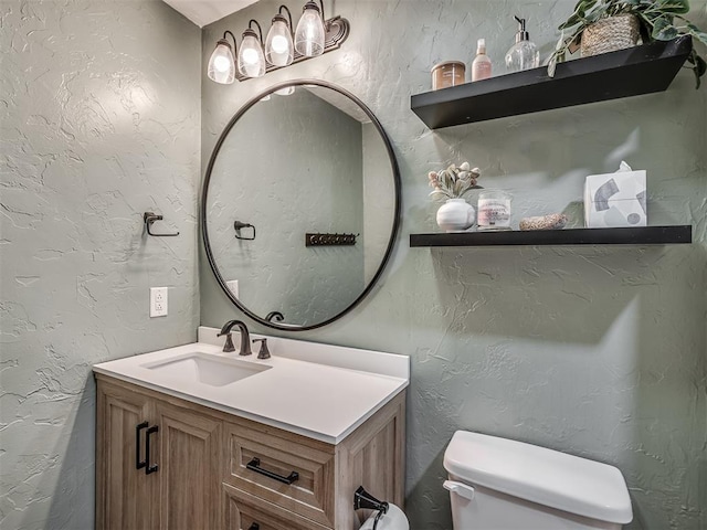 10711 Crystal Creek Dr, Mustang, OK 73064 - half bathroom with toilet, a textured wall, and vanity