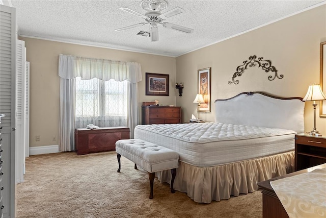 bedroom featuring carpet flooring, a textured ceiling, visible vents, ceiling fan, and ornamental molding