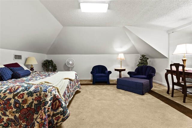 carpeted bedroom featuring baseboards, vaulted ceiling, visible vents, and a textured ceiling