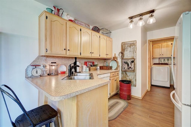 1409 SW 23rd St, Moore, OK 73170 - kitchen featuring a sink, light brown cabinetry, white appliances, light countertops, and a peninsula