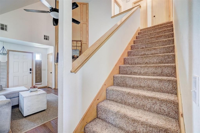 1409 SW 23rd St, Moore, OK 73170 - stairway with wood finished floors, visible vents, high vaulted ceiling, and ceiling fan
