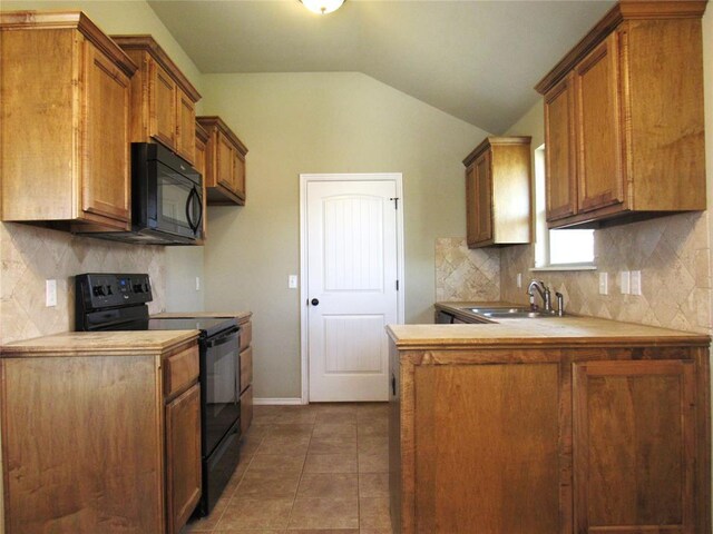 kitchen featuring a sink, decorative backsplash, black appliances, and vaulted ceiling