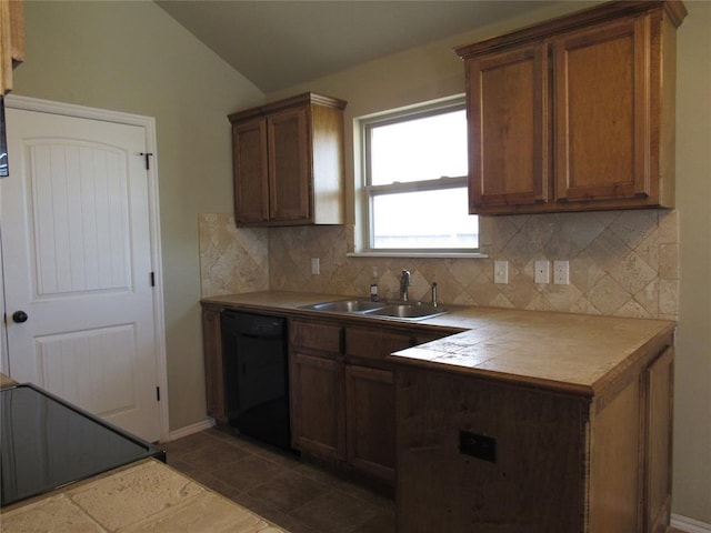 kitchen with backsplash, tile counters, a sink, and dishwasher
