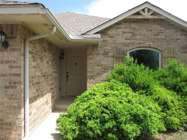 900 Aspen Creek Ter, Yukon, OK 73099 - property entrance with roof with shingles and brick siding