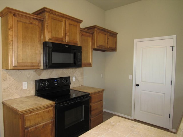 900 Aspen Creek Ter, Yukon, OK 73099 - kitchen featuring black appliances, tile countertops, brown cabinets, and decorative backsplash