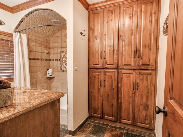 20498 SE 15th St, Harrah, OK 73045 - bathroom featuring stone tile floors, baseboards, shower / tub combo with curtain, and crown molding