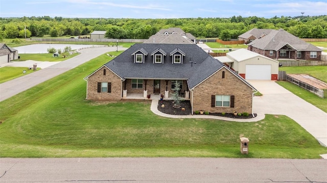 traditional-style home featuring covered porch, brick siding, a garage, and a front yard