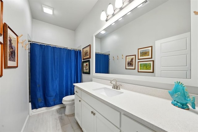 bathroom with vanity, toilet, and shower / bath combo with shower curtain