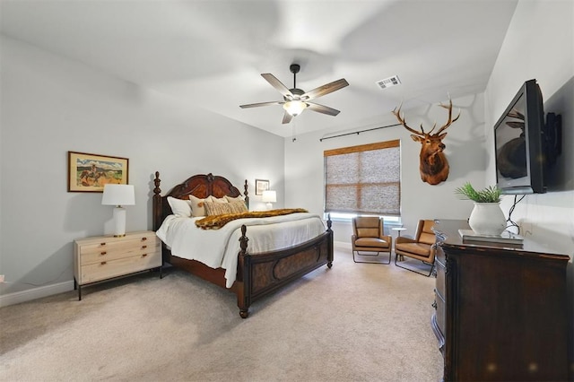 bedroom featuring light colored carpet, ceiling fan, and baseboards