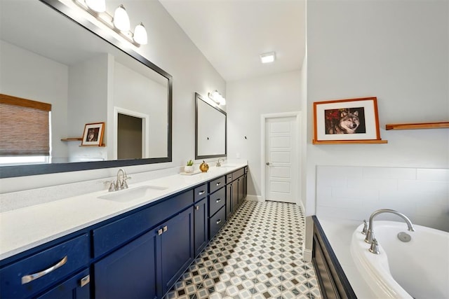 full bathroom featuring double vanity, a bath, baseboards, and tile patterned floors