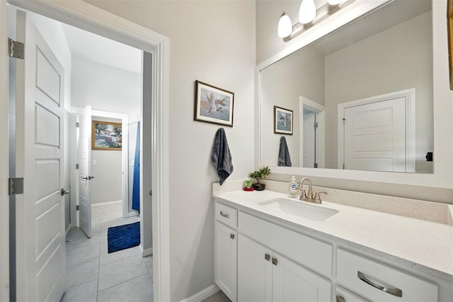 bathroom featuring vanity, baseboards, and tile patterned floors