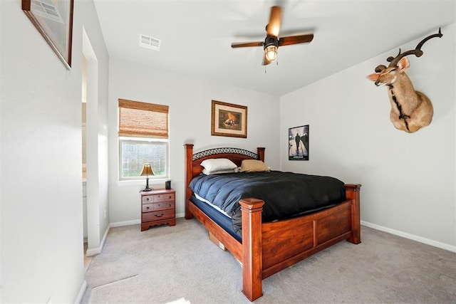 bedroom with light colored carpet, baseboards, and a ceiling fan