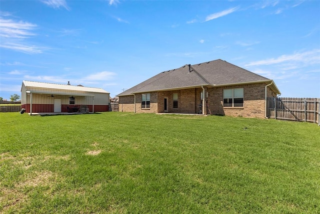 rear view of property featuring brick siding and ceiling fan