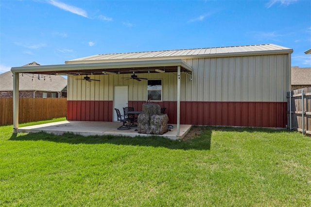 rear view of property featuring a ceiling fan, a patio, and metal roof