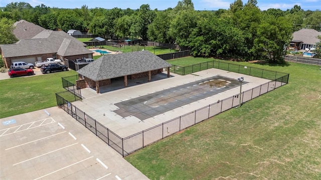 view of swimming pool featuring a tennis court