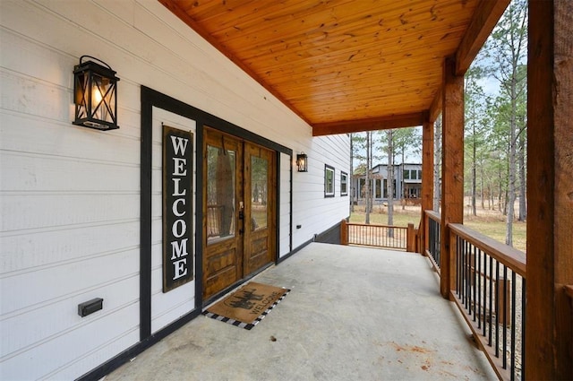 view of exterior entry featuring covered porch