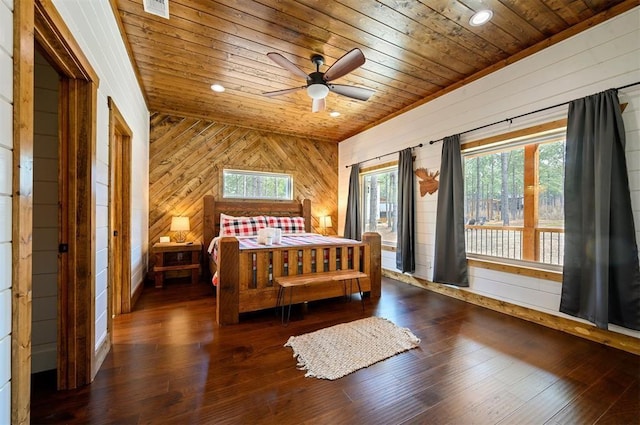 bedroom featuring wooden walls, wood-type flooring, access to exterior, wooden ceiling, and visible vents