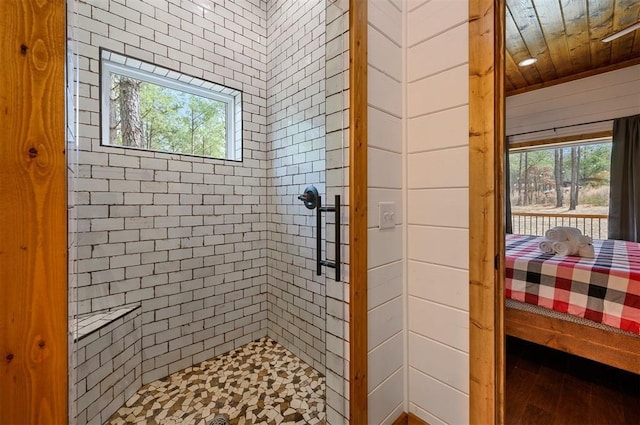ensuite bathroom with wood finished floors, wood ceiling, ensuite bath, and a shower stall