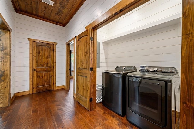 laundry area with visible vents, wood walls, dark wood-style floors, wooden ceiling, and separate washer and dryer