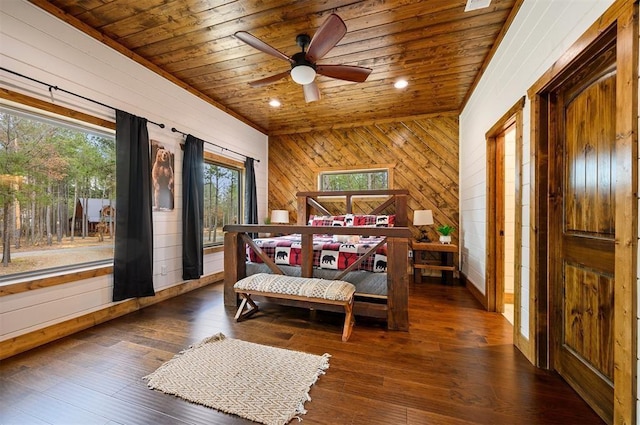 bedroom with wood walls, wood ceiling, hardwood / wood-style floors, and access to exterior