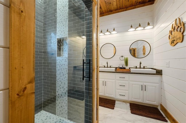 full bathroom with a sink, marble finish floor, wood ceiling, and a shower stall
