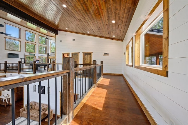 hall with wood ceiling, wood finished floors, vaulted ceiling, and an upstairs landing